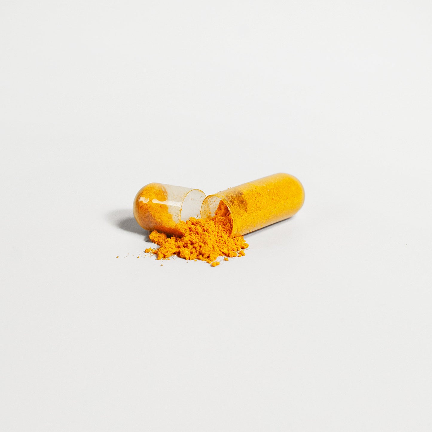 GoldenFlex Turmeric Complex capsules displayed next to the bottle, highlighting the plant-based formulation and clean ingredients.