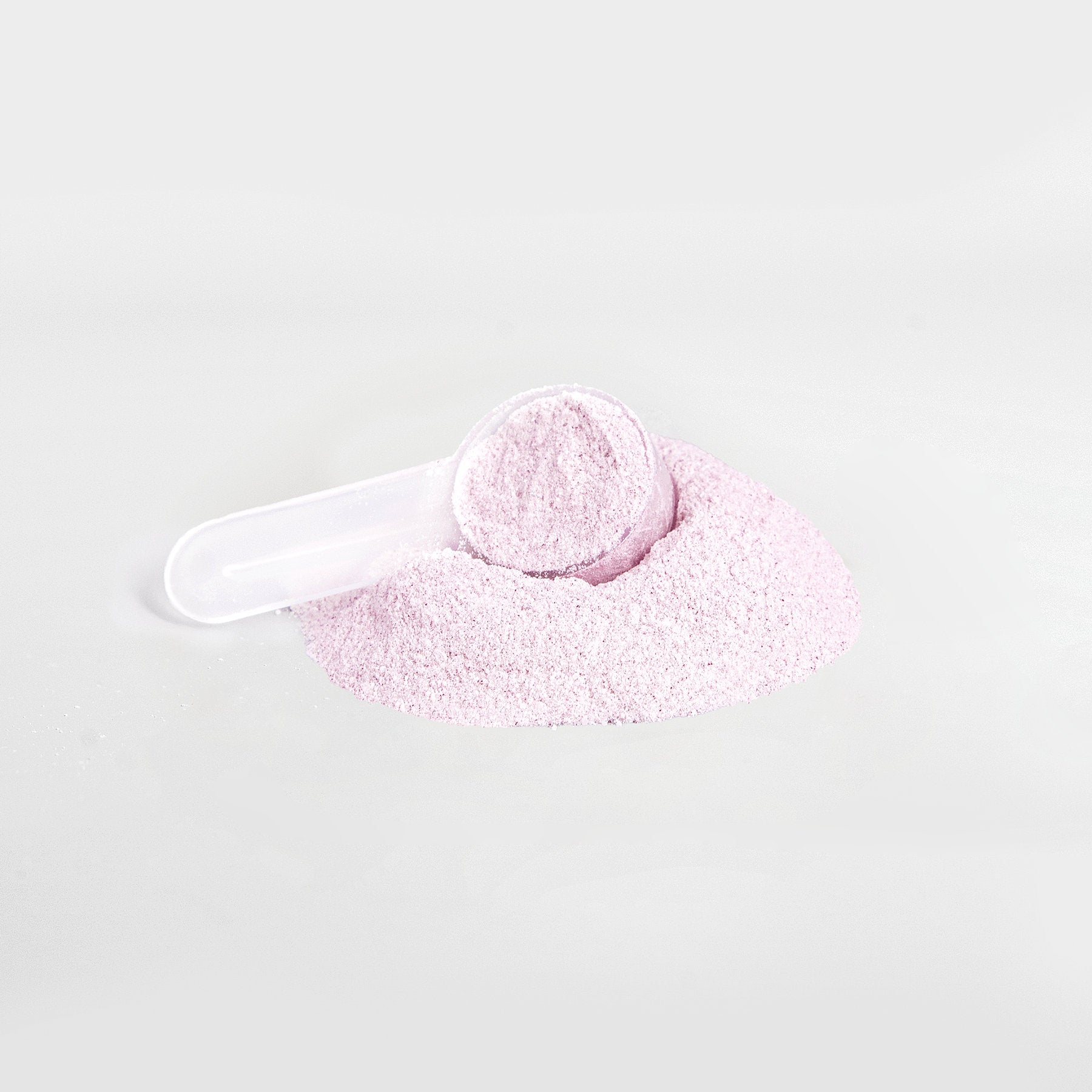 Scoop of Lychee HYDRATION electrolyte powder by Ambedo Wellness, ready to mix for hydration and energy.