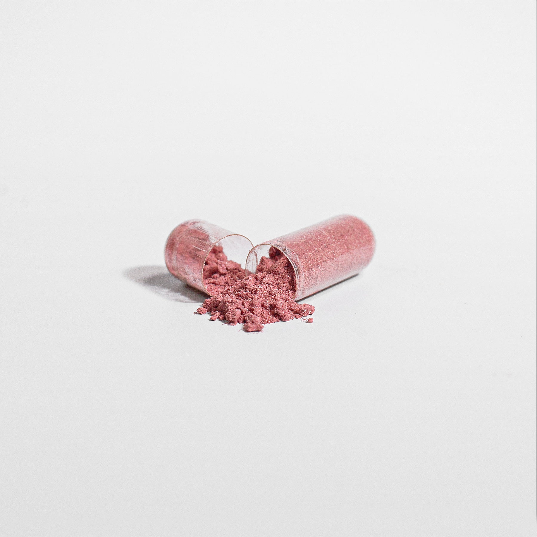 Closeup of Nitro Boost beetroot supplement capsules for nitric oxide production and blood flow support.