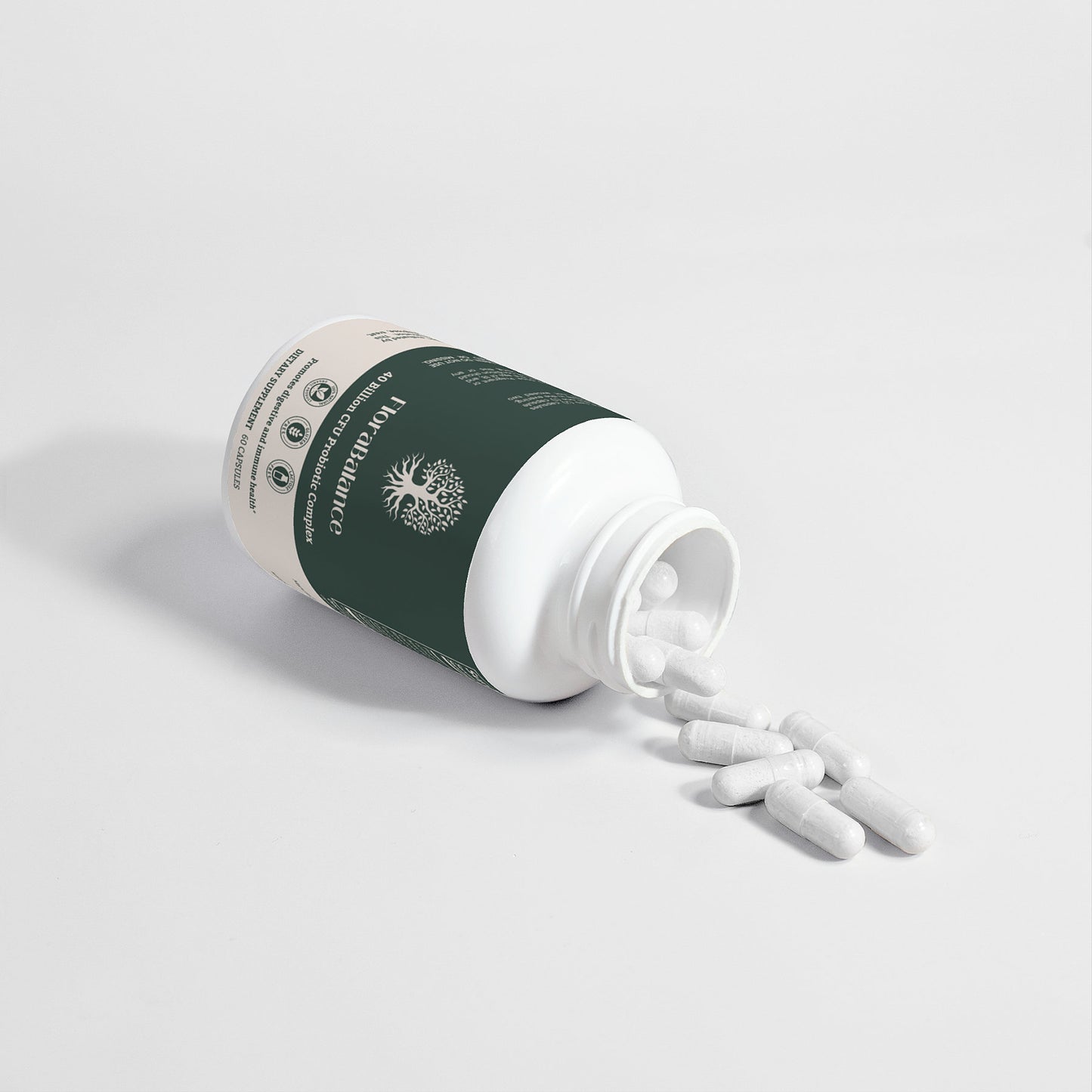 FloraBalance 40 Billion CFU Probiotic Complex capsules spilled on a clean white surface.